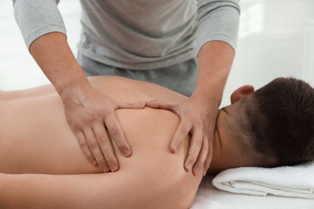 A massage therapist working on a client