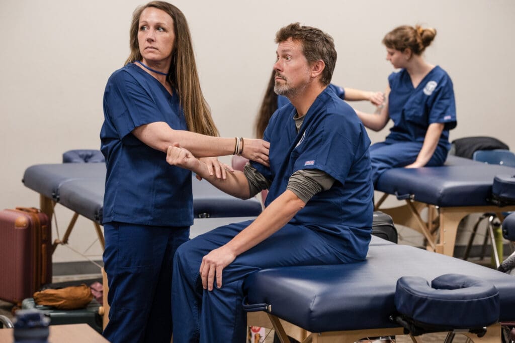 Students getting hands on massage training