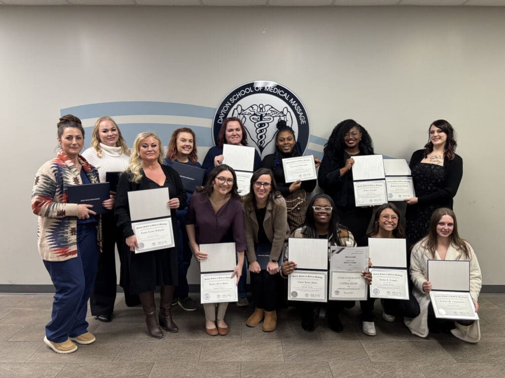 A group of SOMM graduates holding certificates